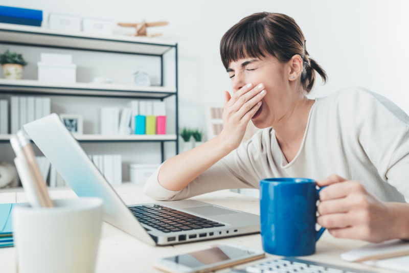 Woman bored at home on computer