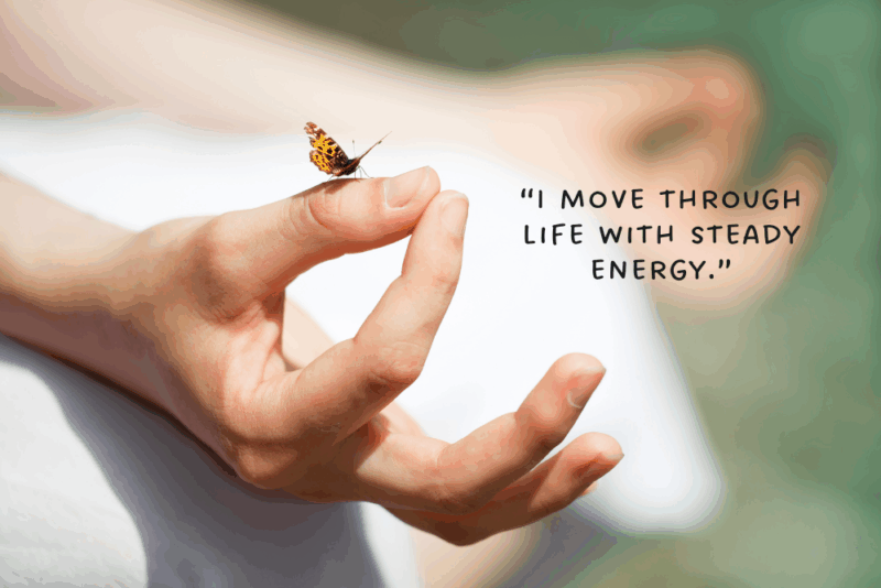 woman butterfly on finger with root chakra affirmation