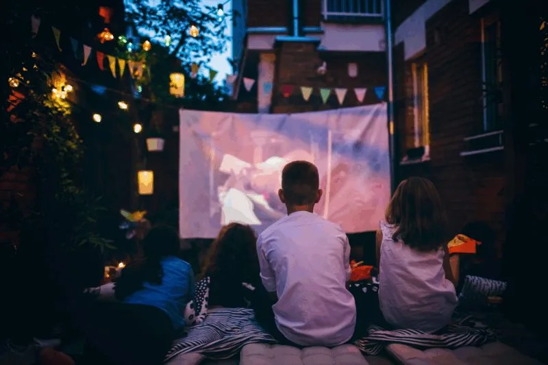 kids watching scary movies on outdoor projector