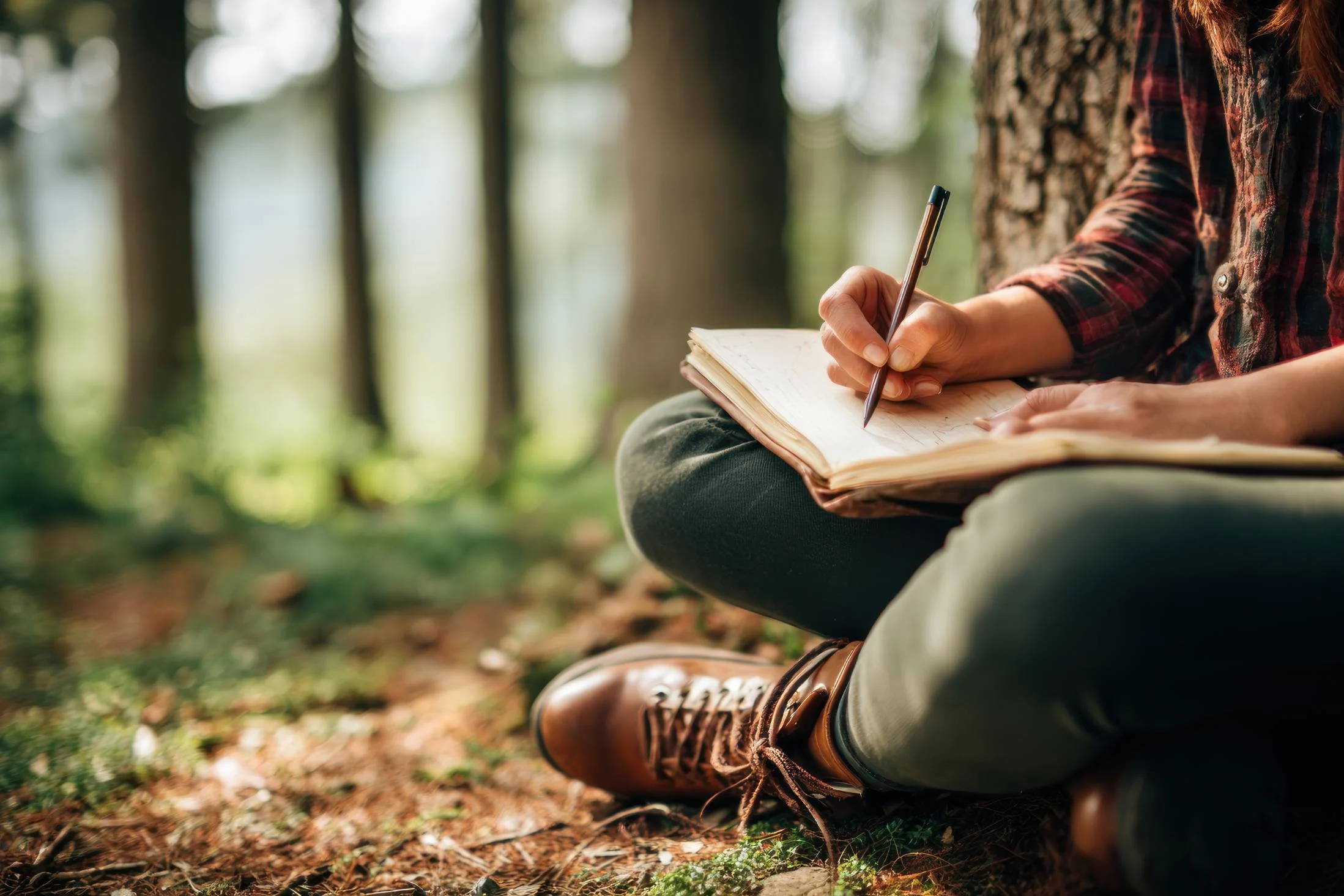 person journaling in the fall outdoors