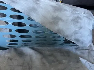 wrapping stormy fabric around laundry basket for homemade tornado costume