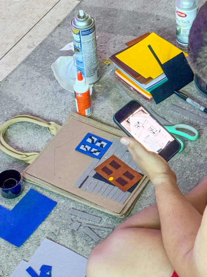 man looking at phone while creating broken house trick or treat bag